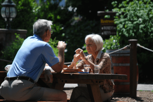 Older couple enjoying lunch at picnic table