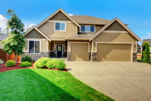 Exterior of beige single family home with 3 car garage