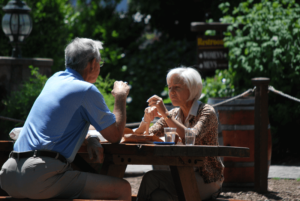 Older couple enjoying lunch at picnic table