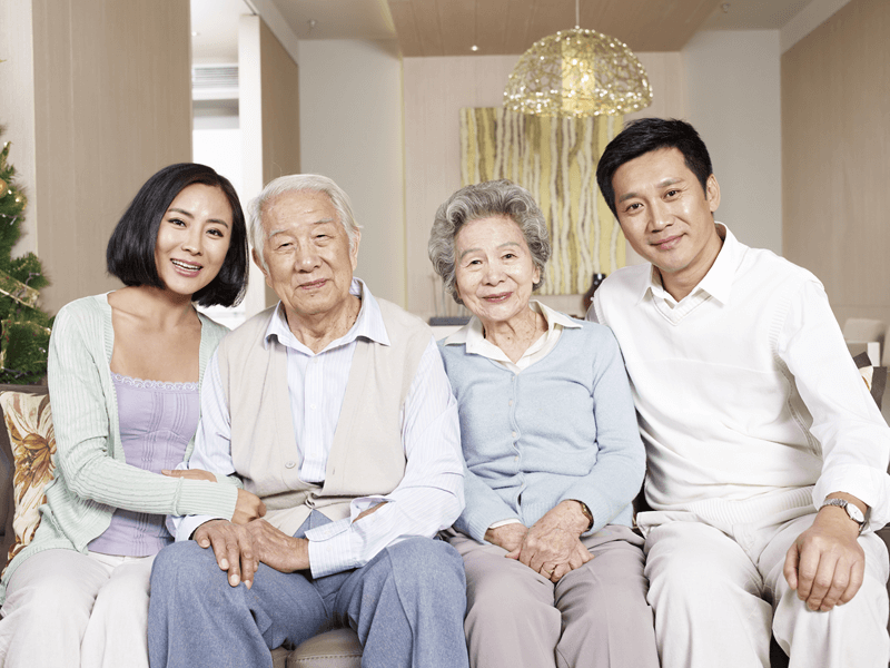 Older parents with their children on couch